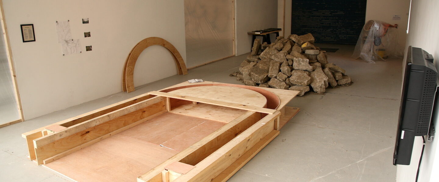 Emma Houlihan Moving Ground Installation View building rubble wood video steel maps drill artist 2010