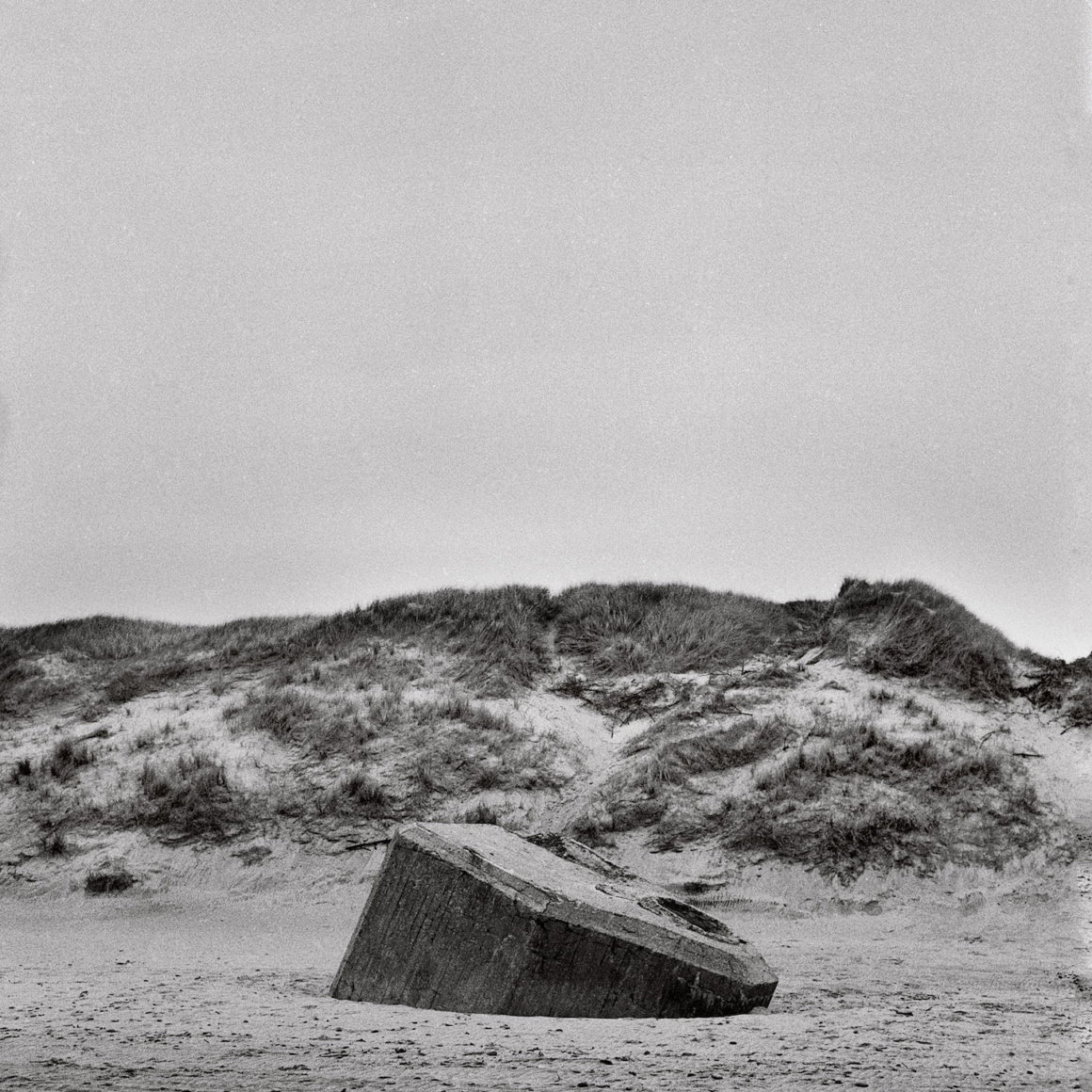 Darn Thorn. Nazi Bunker Sinking into the Sand at Ringkøbing, Denmark. Silver Gelatin Print, 20 x 20 inches, 2022-23