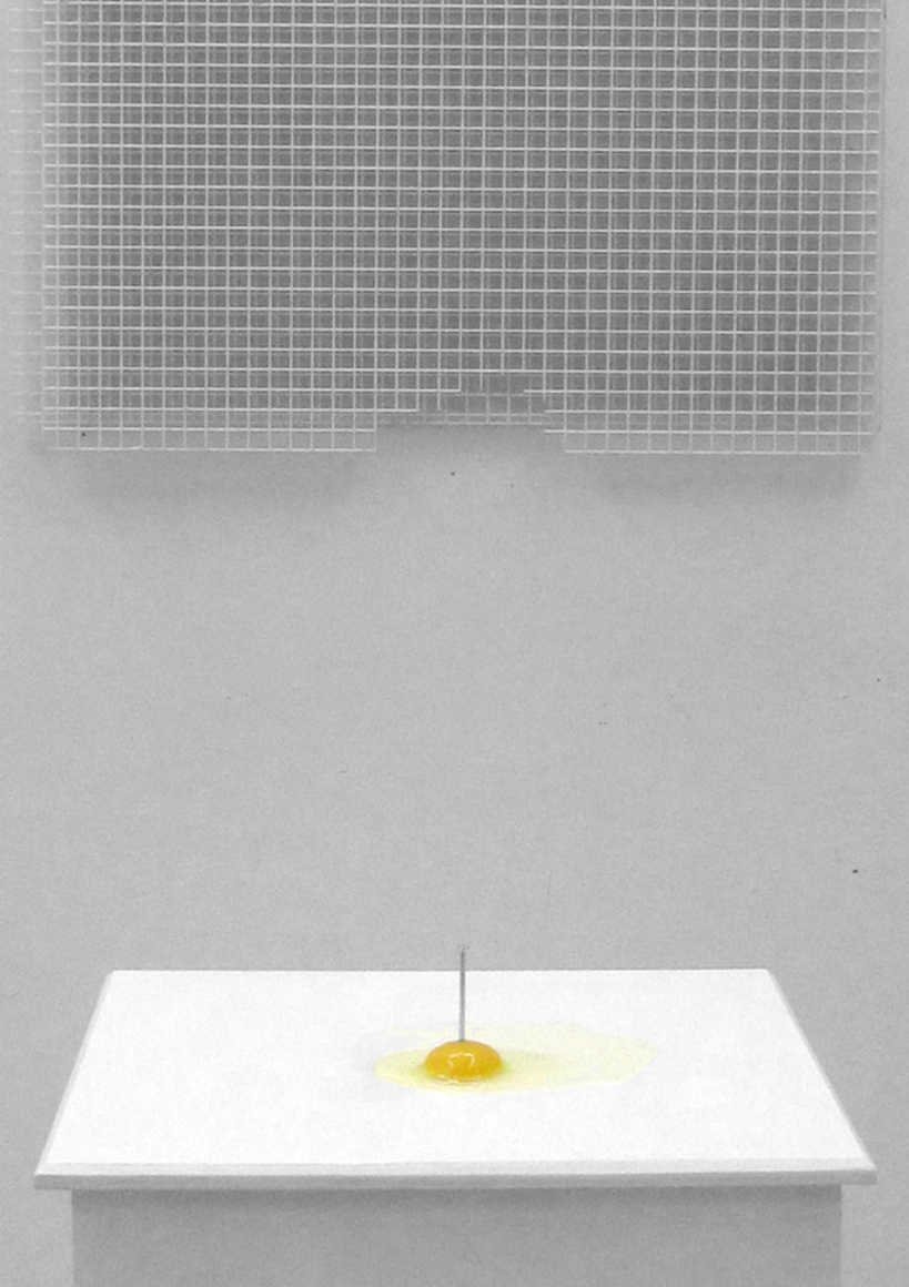Sarah Lundy, Yo[l]ke [Woman:Womb], raw egg on plinth with nail through centre, and Negative, layered plastic grids on wall with section removed, 2012