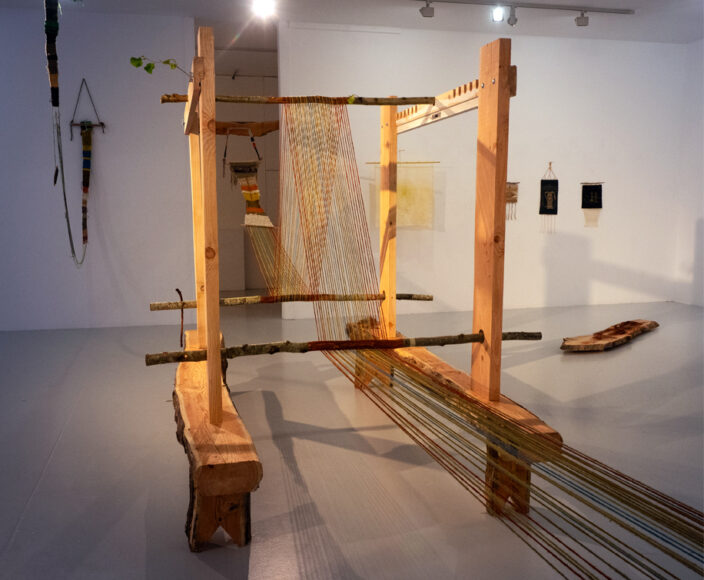 Marta Romani &amp; Karl Logge, Telaio dei giganti (Meitheal úmacha) &amp; Meitheal, or the social fabric, timber, branches, wool. Installation view, LSC 2025 photo credit: Frank de Mol