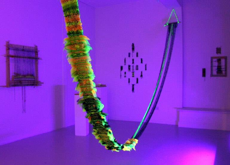 Marta Romani &amp; Karl Logge, A Dragon from Milltown Forest, Wool, Loom, Blacklight Installation view, LSC 2025, photo credit: Logge-Romani