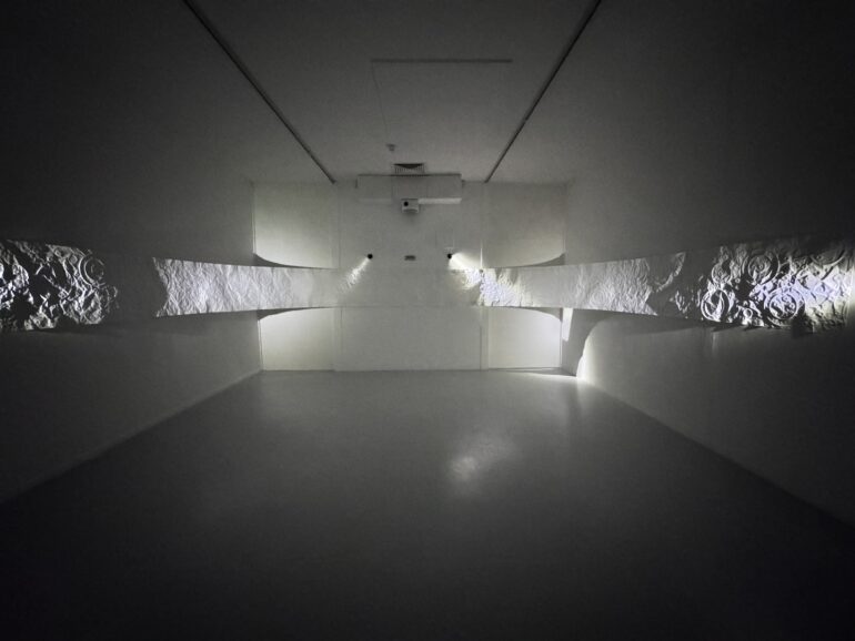 Bernie Colhoun, Forgotten Archive, cup and ring motif blind embossed paper, 1250 x 70 x 440cm, 2025