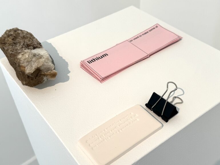 Simon Browne, debris from a matching exercise around 12 rare earth minerals that are used to make a smartphone, printed matter, clip, quartz, porcelain, 2025