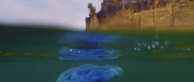 Bettina Seitz, film still Monk, 2024, HD digital film 2.35:1, duration 22 min 42 sec, filmed on Inishmurray Island with temporary, site-responsive sculpture installations in bees wax, cotton fabric and cinnamon, videography by Peter Martin &amp; Fionn Rogers and sound design by Joe Hunt, produced by Tread Softly, supported through an Arts Council Commissions Award and GoFundMe.