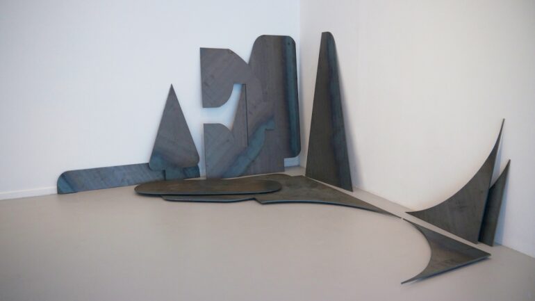 Walker &amp; Walker, REMNANTS OF LOVE (AFTER ROBERT INDIANA), 2013, Cortex steel, 2.8 x 3.5 x 3.8m
The Remnants of Love (after Robert Indiana) consists of metal offcuts of the negative spaces which surround the individual letters of Robert Indiana’s iconic LOVE sculpture. Consisting of large slabs of steel stacked on top of each other, leaning against the wall, it is a memorial of sorts yet it speaks of the incommensurability of memory. Chaotic in its appearance, making concrete the necessary support to articulate the word which would have been previously discarded or unappreciated, left as a residue in a workshop, it possesses an ambiguous materiality between melancholia and affirmation.