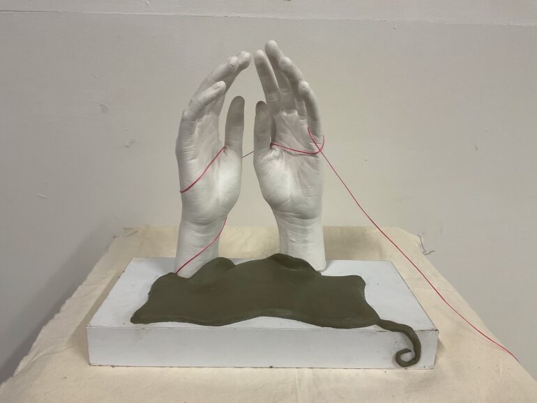 Fatoumata Gandega, FROM LAND TO SEA, 2025Life Casting Hand, (Crystacal White Plaster), Green Chevant NSP Clay Medium, Wax Thread Pink.