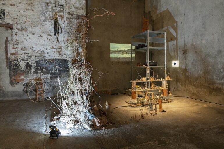 Aideen Farrell, Dredge, Sift, Sink. Installation view. Shown as part of Waystation, TU Dublin MA Degree Show at The Complex, Dublin. October 2024. Metal shelf, glass sheets, bricks, unfired paper clay, terracotta, porcelain fragments, bicycle chains &amp; tubes, slide projectors, 35mm slides, and various found materials from the Royal Canal, Mullingar to Athlone “Old Rail Trail”, and Corlea Bog. Photo credit: Susan Gogan.